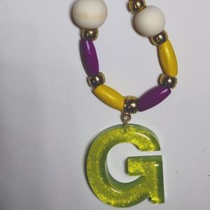 Letter G necklace with multi colored wood beads.